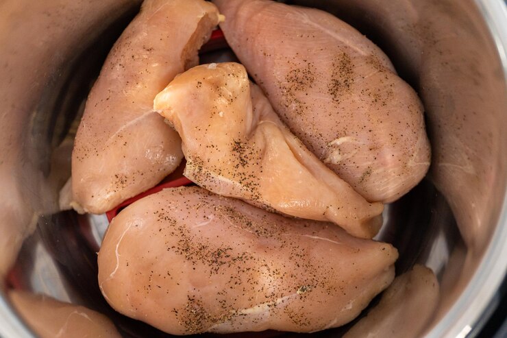 Instant Pot chicken recipes showing cooked chicken in broth
